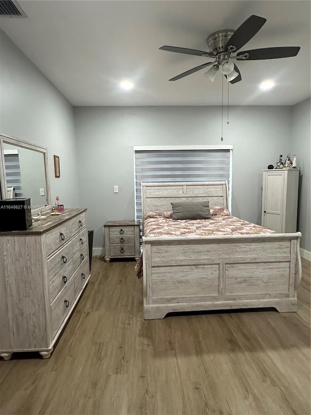 bedroom featuring ceiling fan and hardwood / wood-style flooring