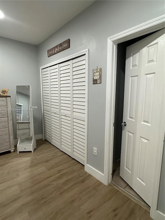 unfurnished bedroom featuring a closet and hardwood / wood-style flooring