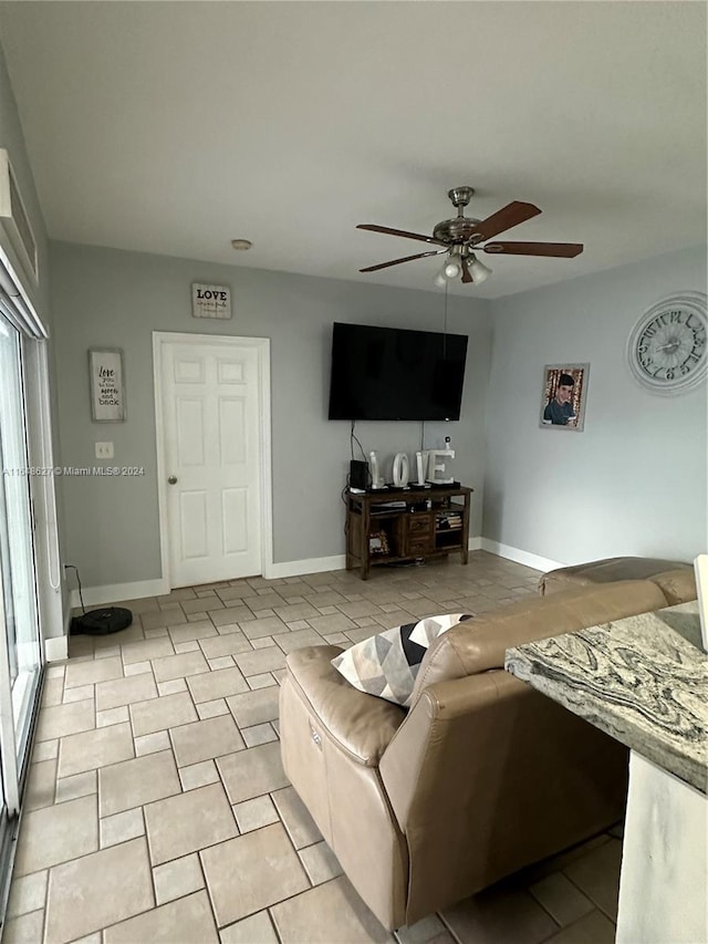 living room with ceiling fan and light tile patterned flooring