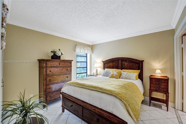 bedroom featuring light tile patterned floors, crown molding, and a textured ceiling