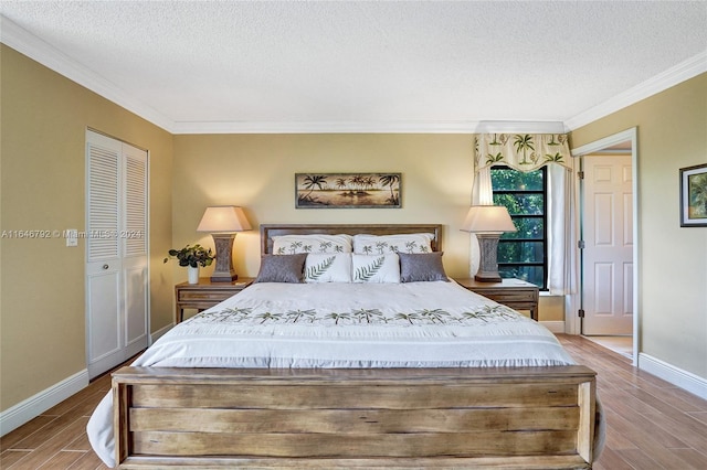 bedroom featuring a textured ceiling, ornamental molding, a closet, and light hardwood / wood-style floors