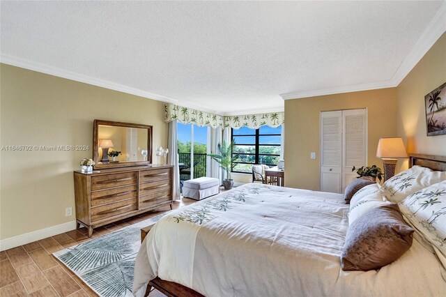 bedroom with a closet, hardwood / wood-style floors, a textured ceiling, and ornamental molding