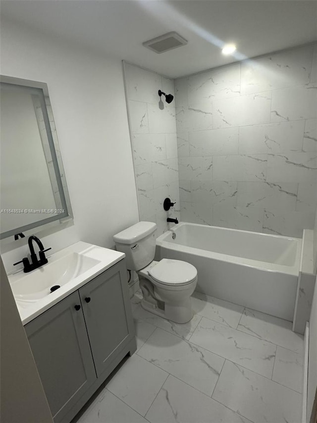 full bathroom with vanity, toilet, and tiled shower / bath