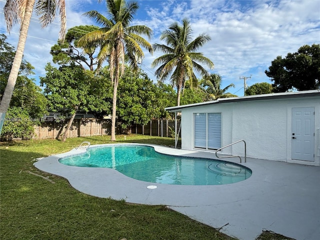 view of swimming pool with a patio area and a lawn