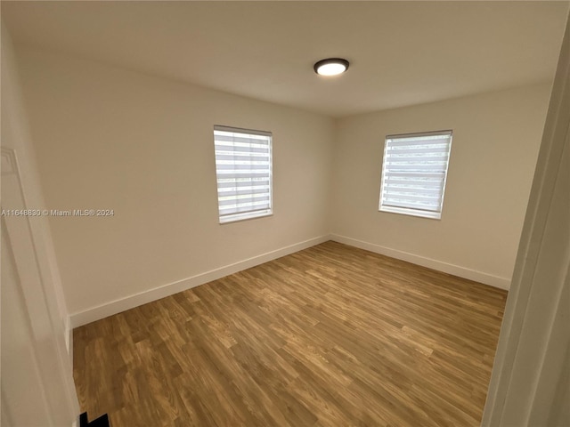 empty room with hardwood / wood-style floors