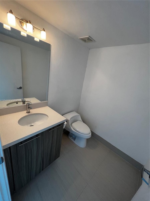 bathroom featuring toilet and vanity