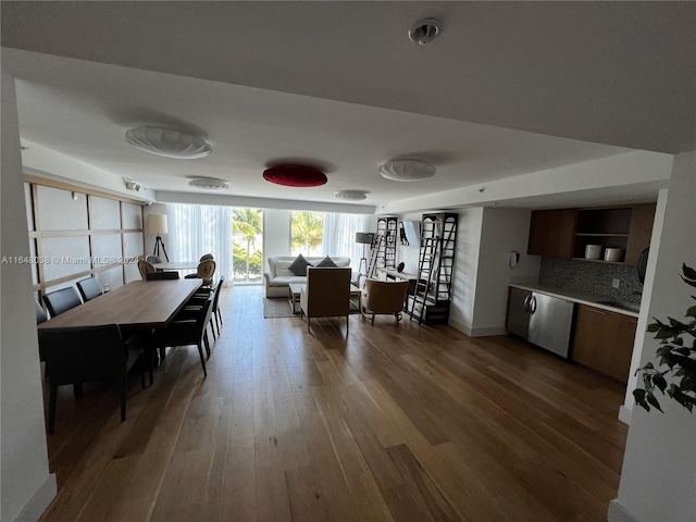 dining space with sink and dark wood-type flooring