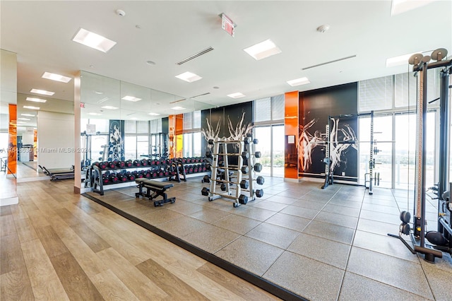 exercise room featuring floor to ceiling windows and light hardwood / wood-style floors