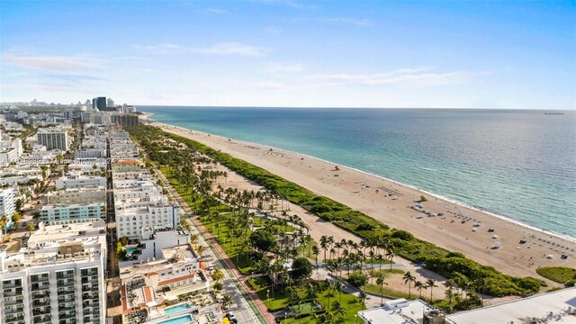 bird's eye view featuring a water view and a beach view