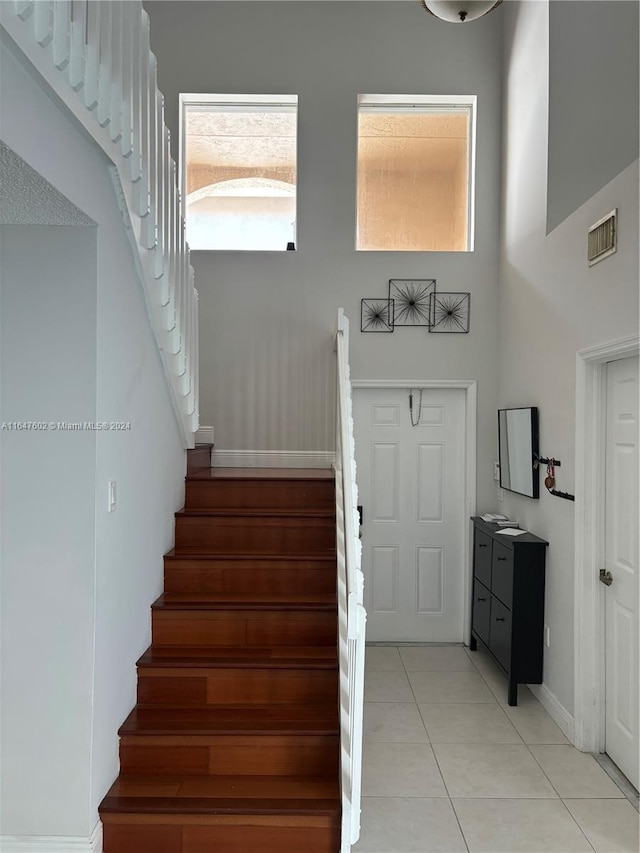 staircase featuring tile patterned flooring