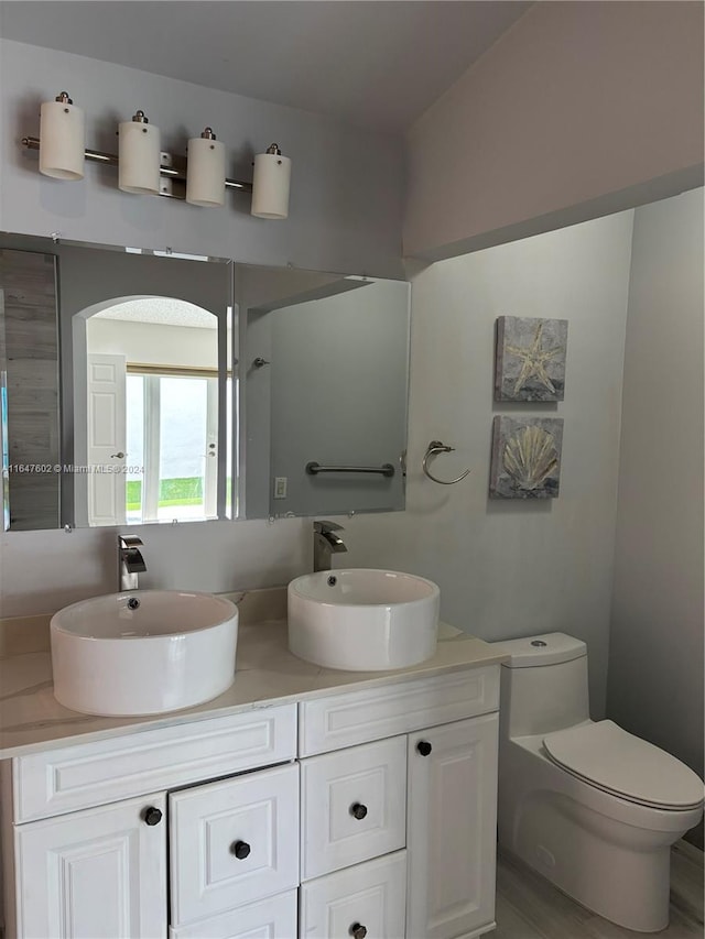 bathroom featuring toilet and vanity