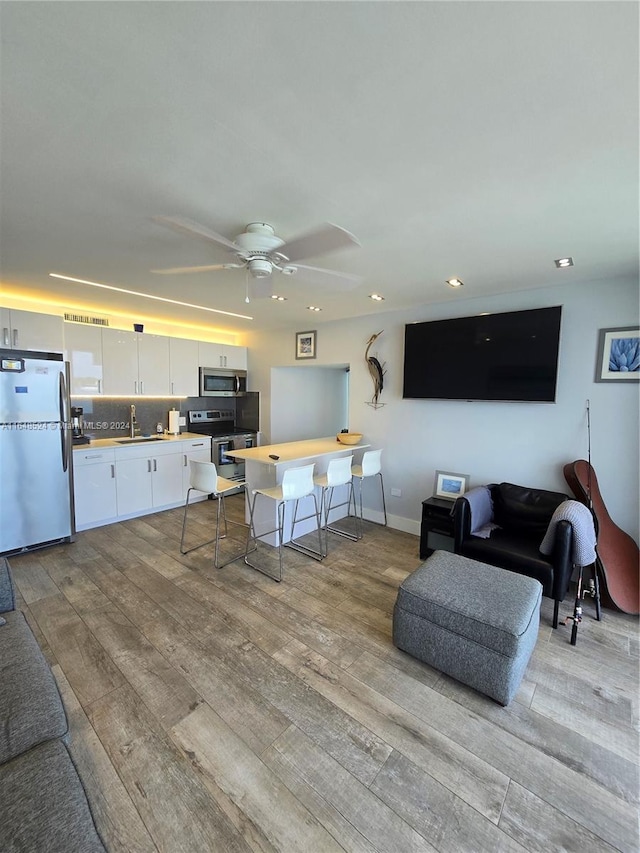 interior space with recessed lighting, light wood-style flooring, and a ceiling fan