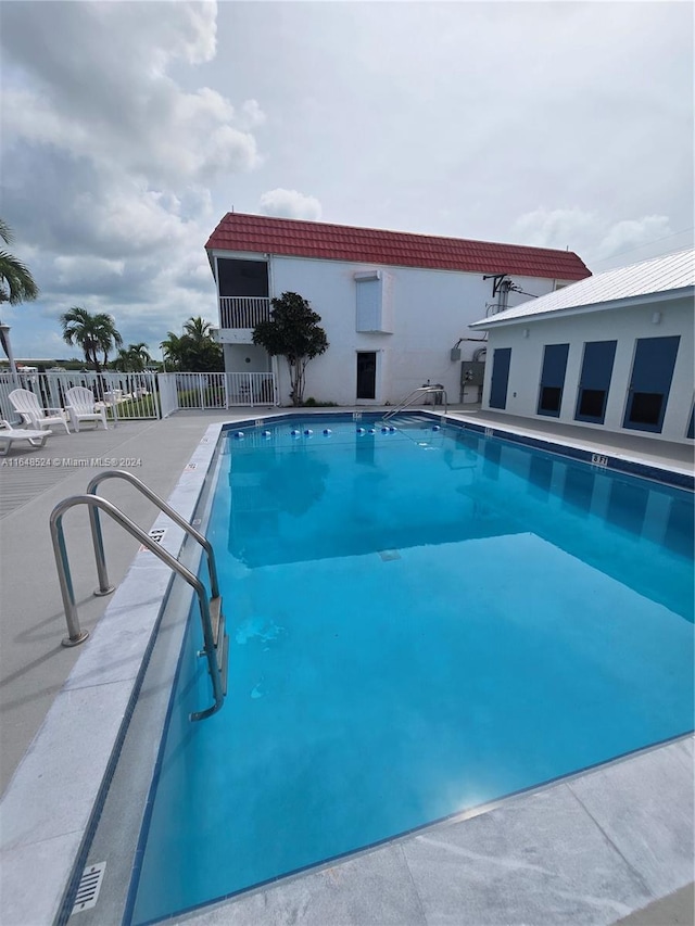 pool featuring a patio and fence