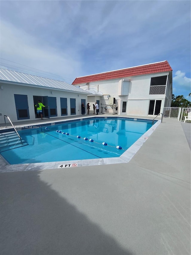 pool with fence and a patio