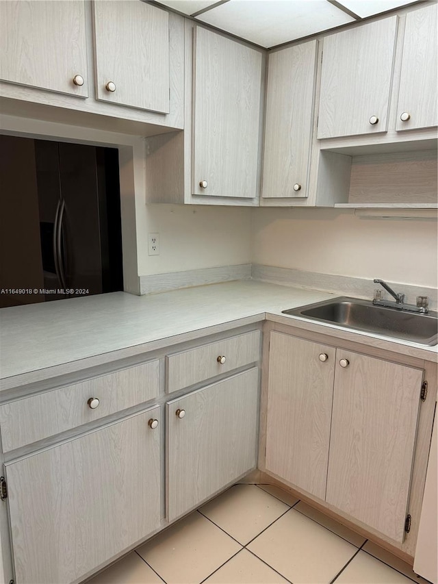 kitchen featuring light tile patterned flooring and sink