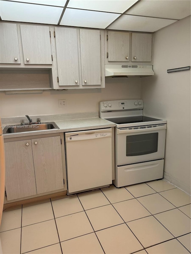 kitchen featuring light tile patterned floors, sink, and white appliances