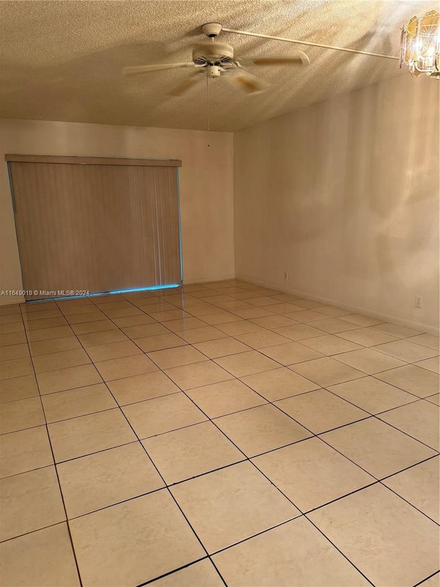 unfurnished room featuring light tile patterned floors and a textured ceiling