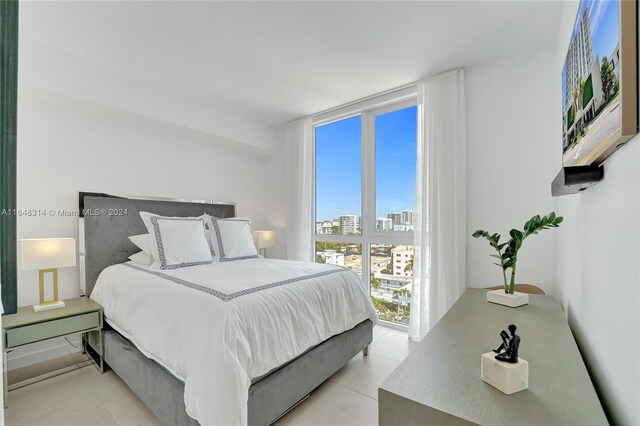 tiled bedroom featuring floor to ceiling windows