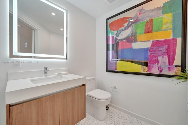 bathroom with tile patterned flooring, toilet, and vanity