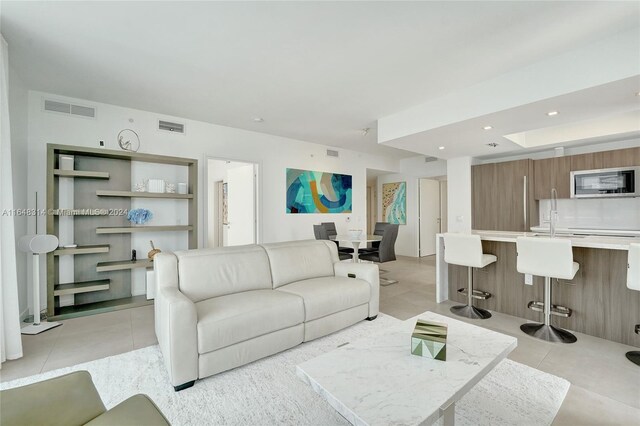 living room with light tile patterned floors