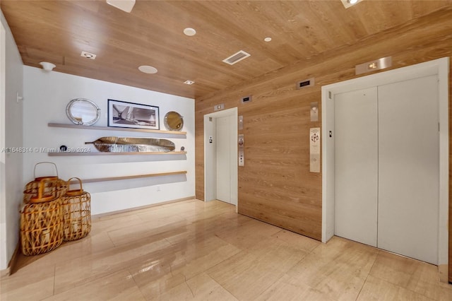 hallway with wooden ceiling and elevator