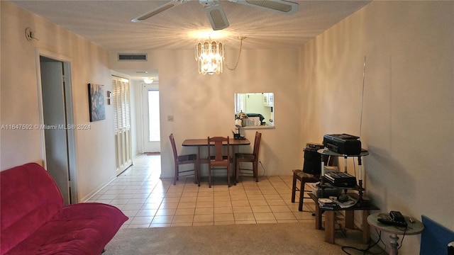 dining room featuring ceiling fan with notable chandelier and light tile patterned floors