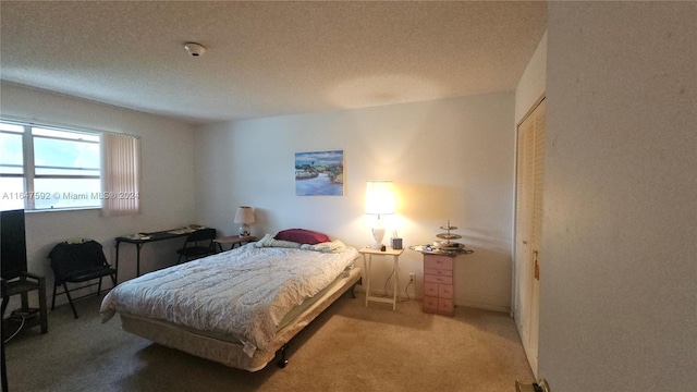 carpeted bedroom featuring a textured ceiling