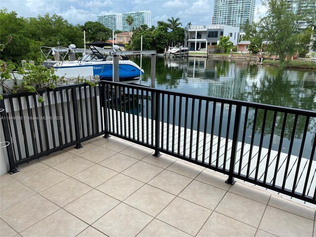 balcony with a boat dock and a water view