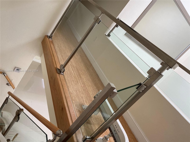 stairs featuring hardwood / wood-style flooring