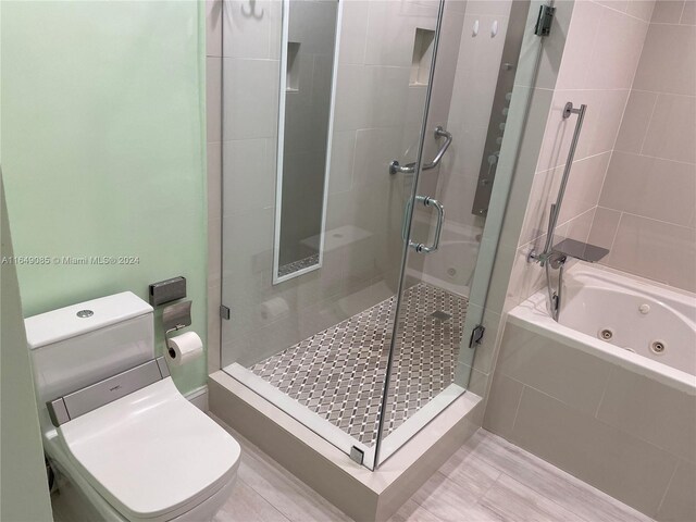 bathroom with tile patterned floors, plus walk in shower, and toilet