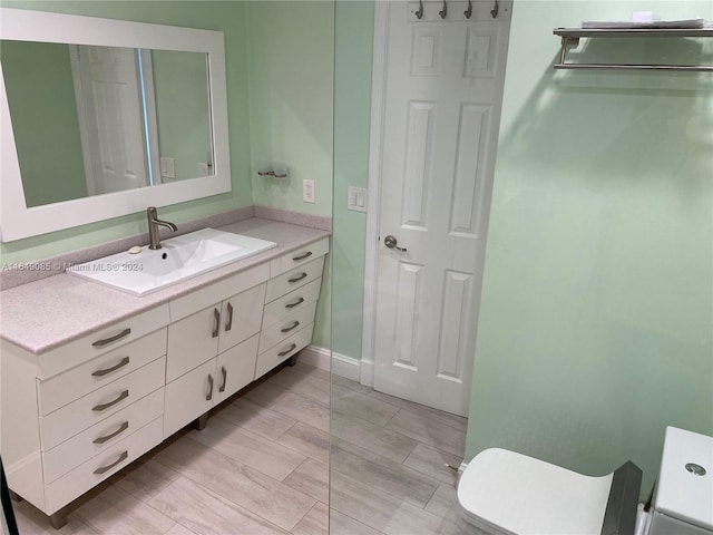 bathroom with toilet and vanity