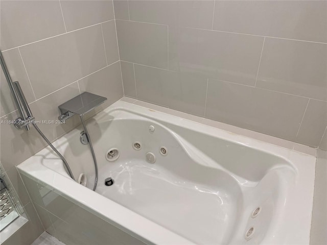 bathroom with a relaxing tiled tub