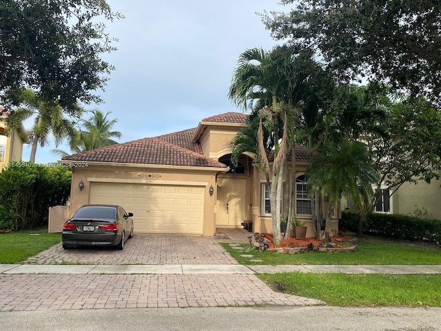 mediterranean / spanish-style house with a garage