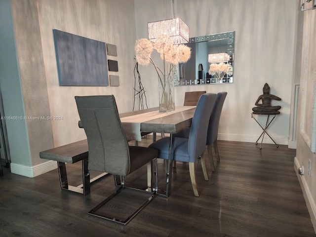 dining space featuring a chandelier and dark wood-type flooring