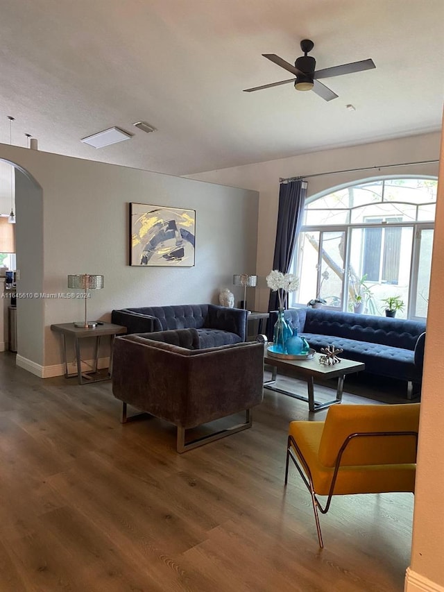 living room featuring wood-type flooring and ceiling fan