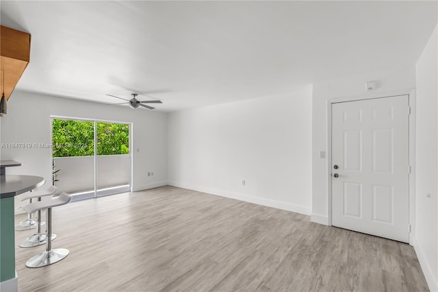 unfurnished living room with ceiling fan and light wood-type flooring