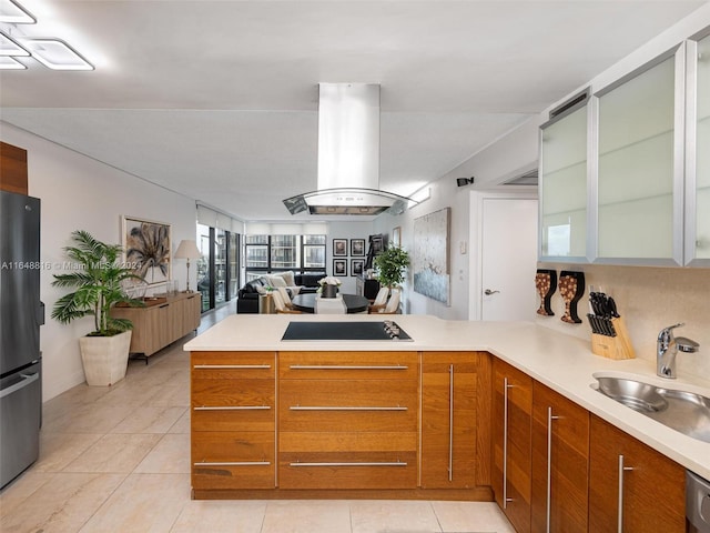 kitchen with sink, stainless steel appliances, kitchen peninsula, island exhaust hood, and light tile patterned flooring