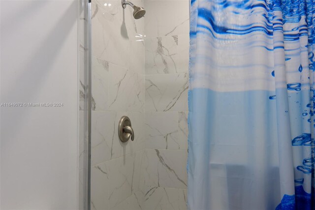 bathroom with a shower with shower curtain