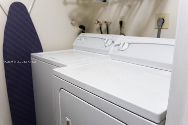 clothes washing area with separate washer and dryer