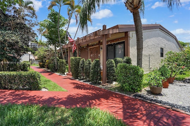 view of side of property featuring stucco siding