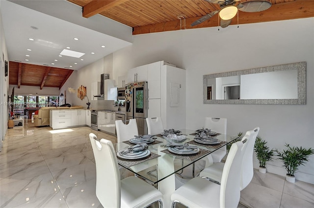 dining space with high vaulted ceiling, wood ceiling, beam ceiling, and a ceiling fan