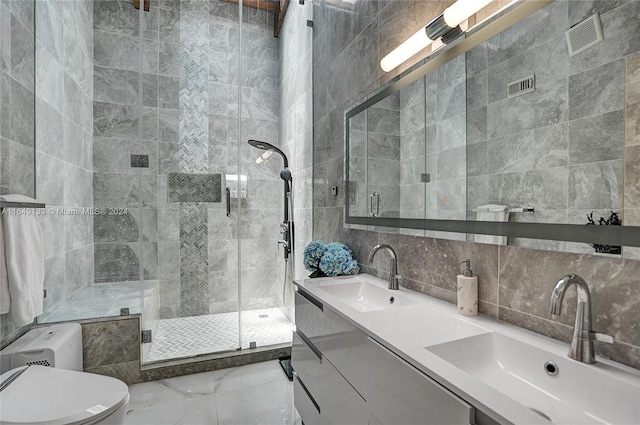 bathroom featuring a stall shower, visible vents, a sink, and double vanity