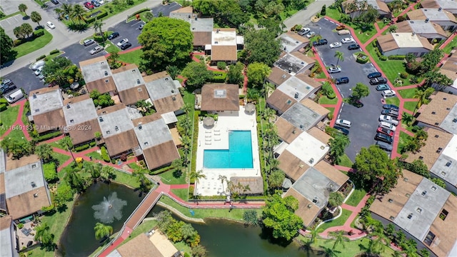 drone / aerial view featuring a residential view and a water view