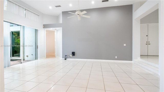 unfurnished room featuring visible vents, baseboards, a high ceiling, light tile patterned flooring, and recessed lighting