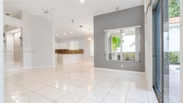 unfurnished room featuring ceiling fan and light tile patterned floors