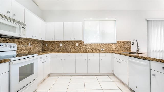 kitchen featuring white cabinets, white appliances, backsplash, and a sink