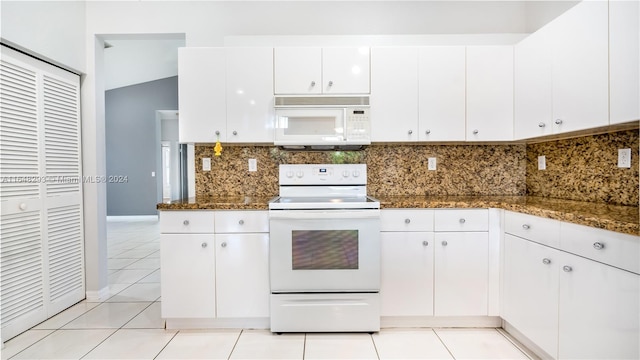 kitchen featuring white appliances, light tile patterned floors, white cabinets, and tasteful backsplash