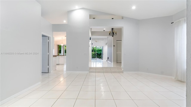 unfurnished room featuring vaulted ceiling and light tile patterned floors