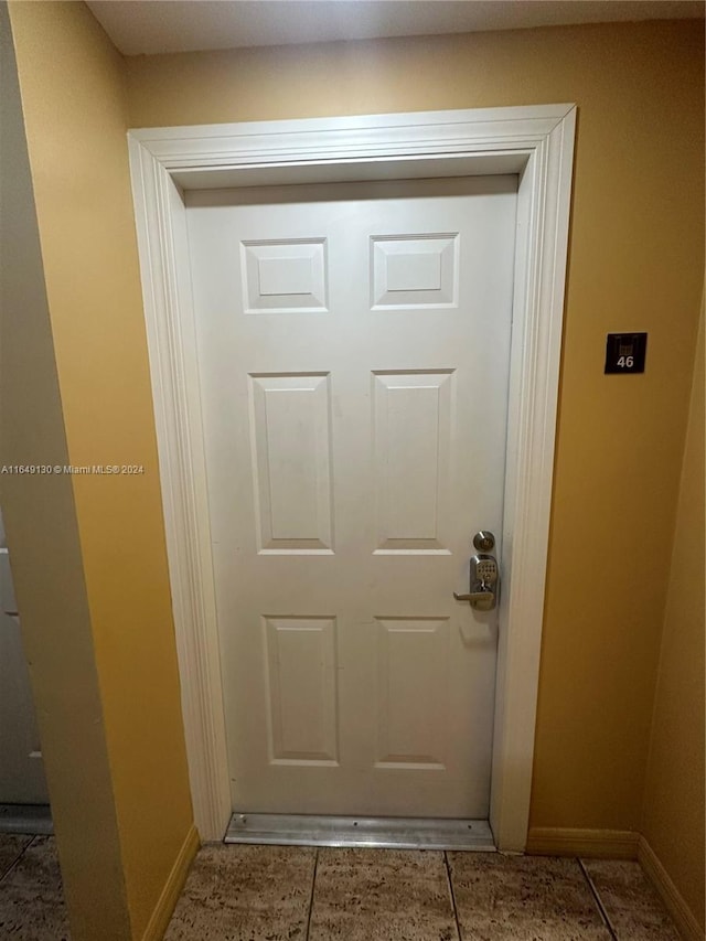 doorway with tile patterned flooring