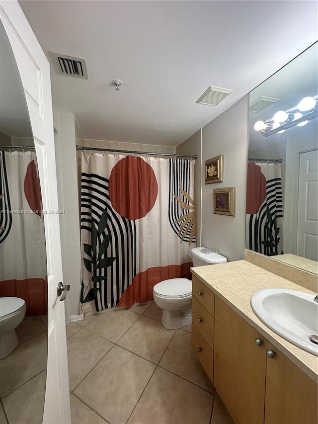 bathroom with tile patterned floors, vanity, and toilet